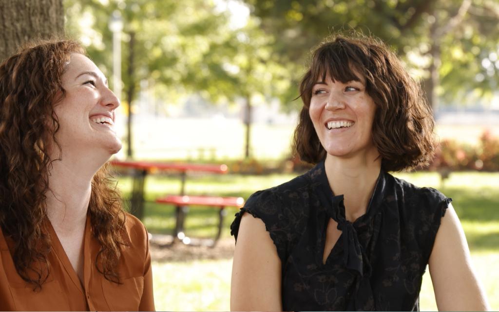 Two students laughing outside