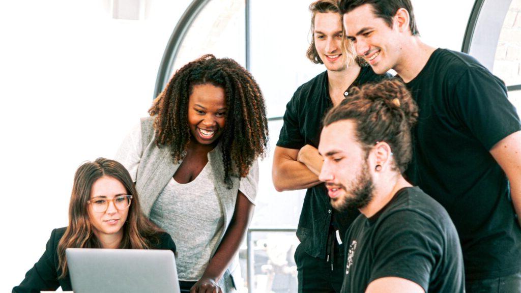 Group of students around a laptop