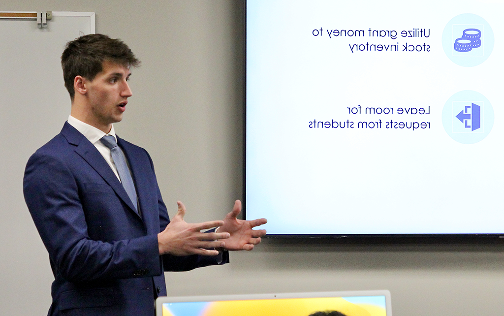 Student in a suit giving a presentation